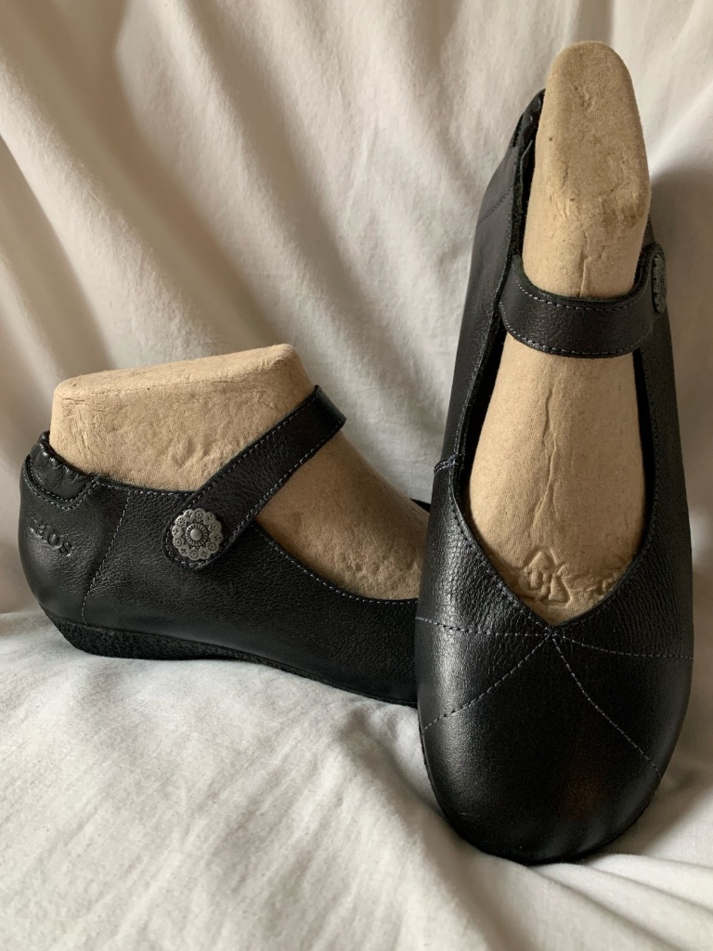 Taos Footwear black leather Mary Janes flats with silver medallion